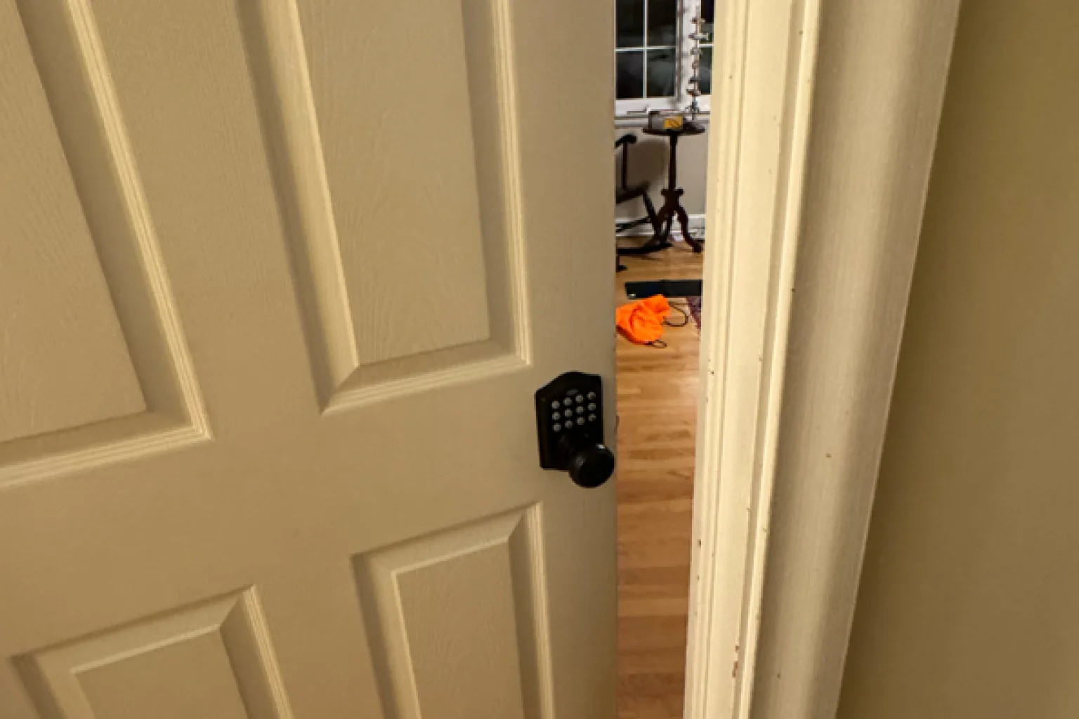 Black digital keypad lock on white interior door